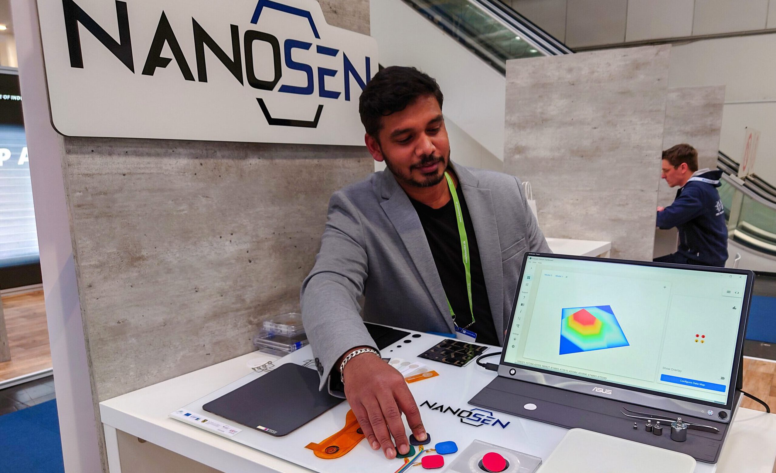 Raja demonstrates NanoSen technologies at the booth.